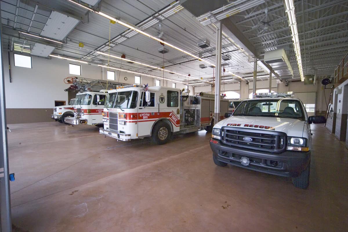Emergency response vehicles parked in garage.