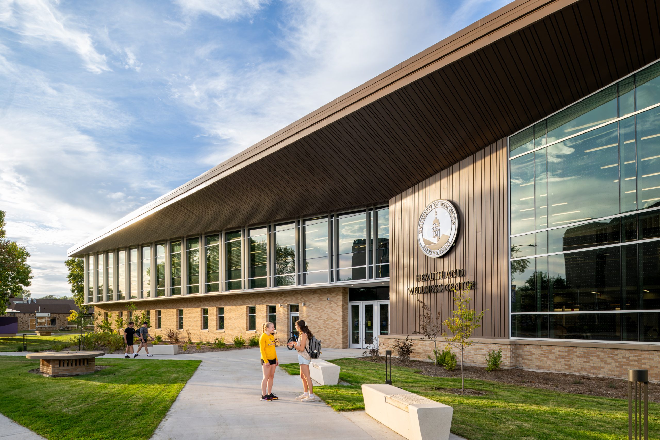 Students talking outside the Health and Wellness Center building