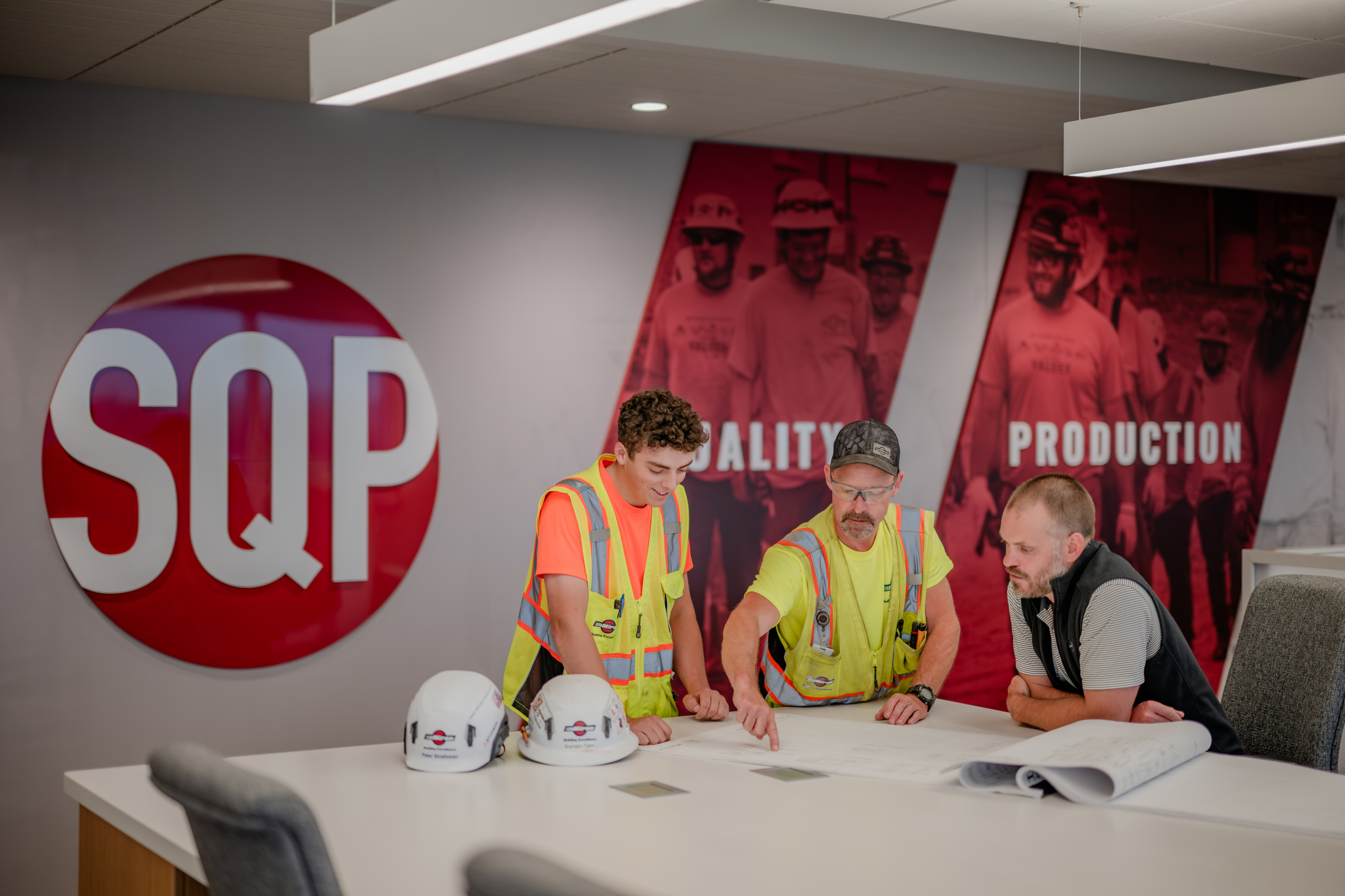 Miron team reviewing plans at a Safety, Quality, Production display