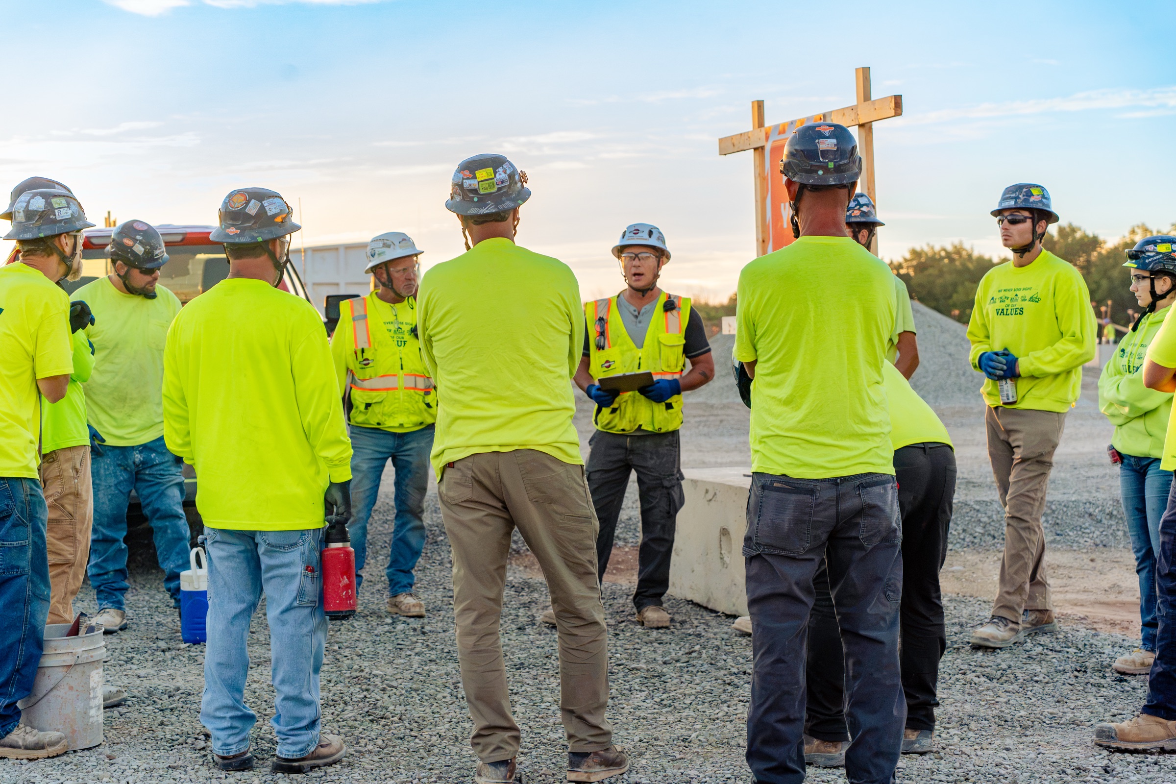 Miron crew gathered in a circle for a jobsite safety huddle