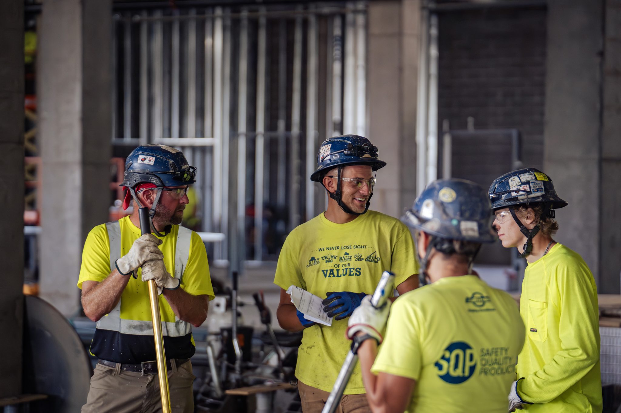 Miron craftspeople in hard hats chatting during a training session