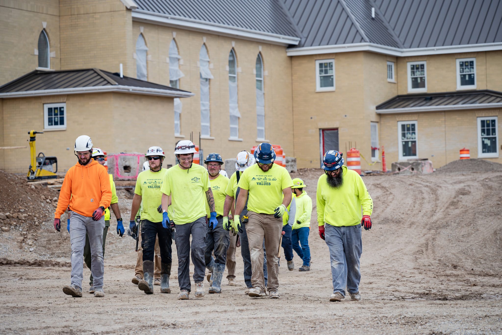 Miron field crew in hard hats walking across a jobsite