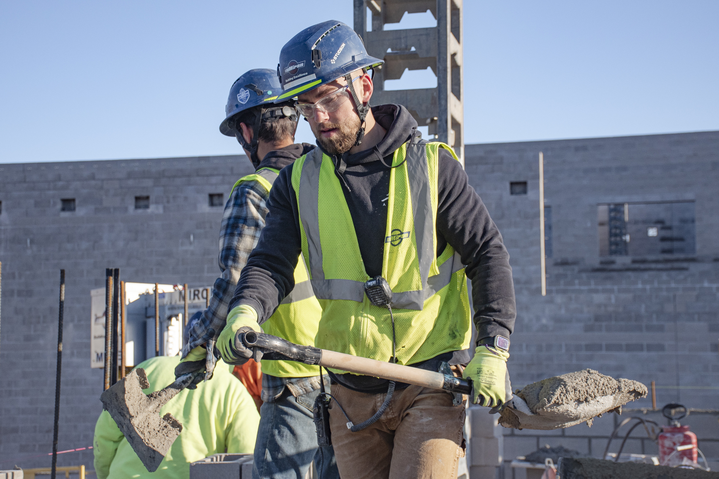 Youth apprentice shoveling material on a jobsite