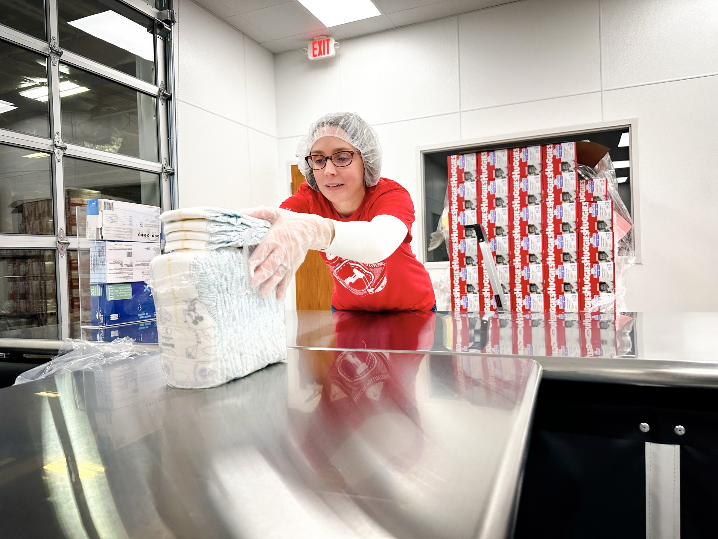 Miron volunteer packing supplies at a United Way distribution center